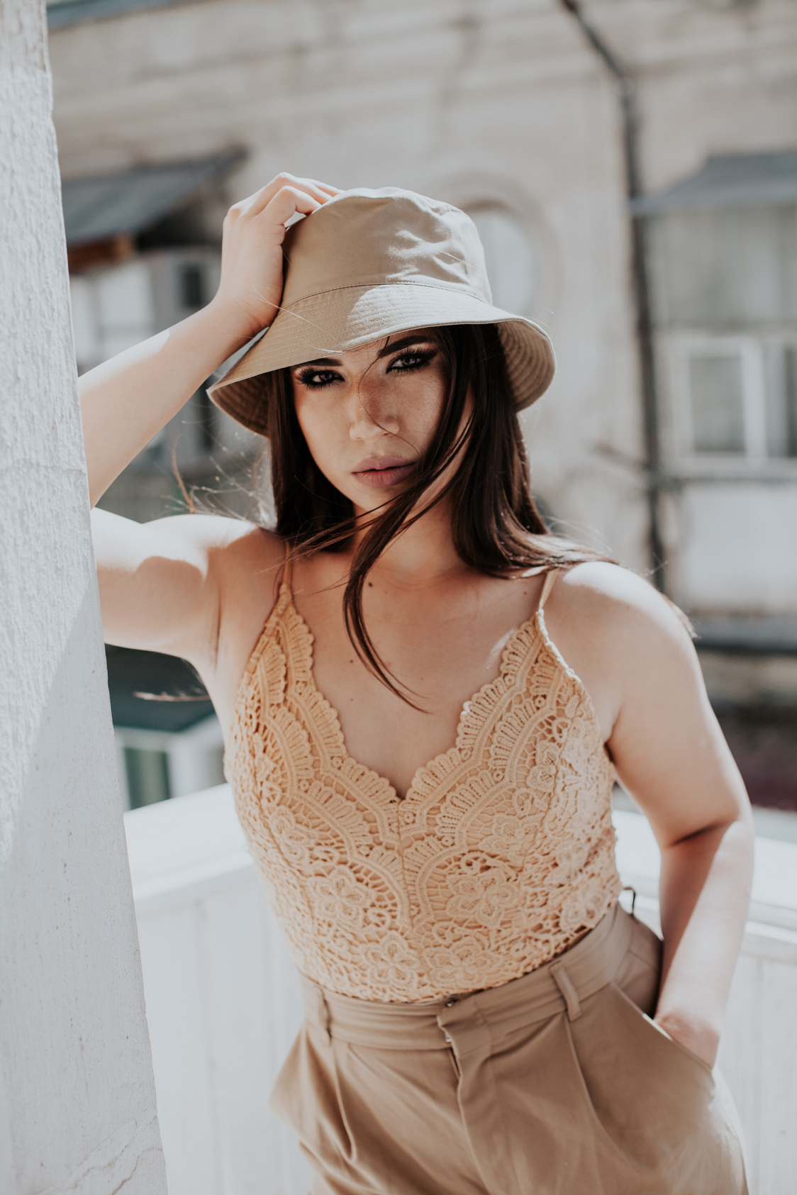 Beautiful asian woman brunette in beige fashionable clothes with hat